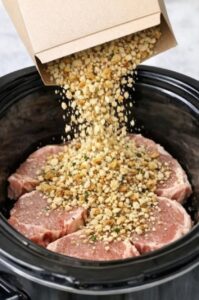Slow cooker pork chops topped with buttery stuffing